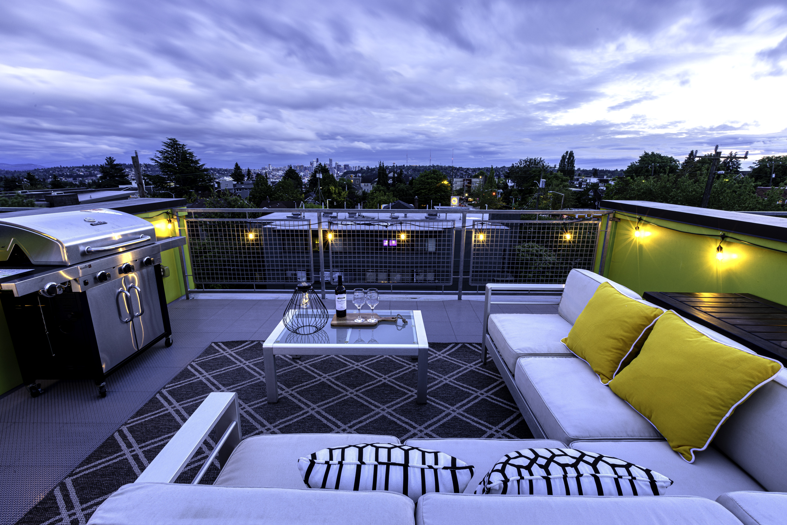 Private rooftop deck with outdoor dining and gas grill